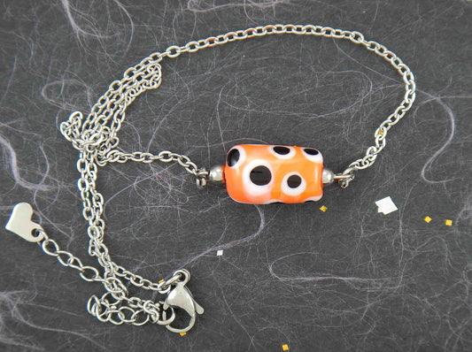 14-inch necklace with bright orange glass cylinder, black and white dots (Murano-style glass handmade in Montreal), stainless steel chain