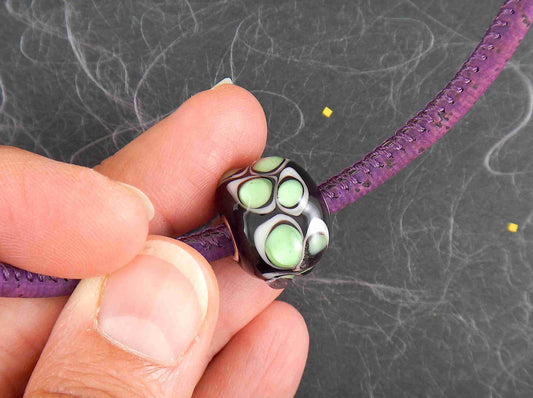 Choker necklace with deep purple cylinder glass bead (Murano-style glass handmade in Montreal), 3-dimensional white-translucent green dots, purple cork cord, stainless steel clasp