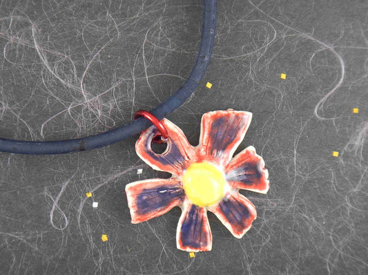 16-inch necklace with blue-red-yellow ceramic daisy flower pendant handmade in Montreal, dark blue cork cord, aluminum ring, stainless steel clasp