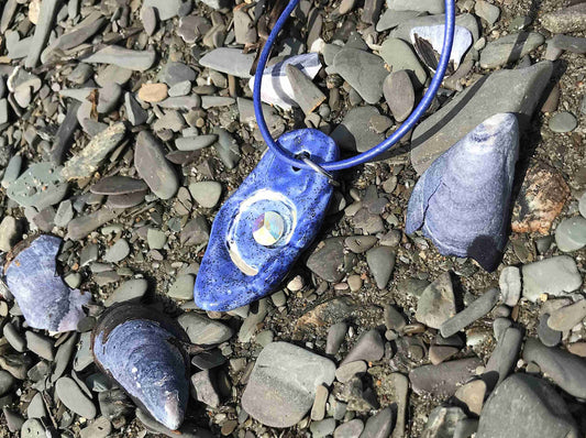 18-inch necklace with jean blue spiralled shell-like pendant handmade in Montreal, 6mm Crystal AB Swarovski Rivoli chaton, jean blue leather cord, stainless steel clasp