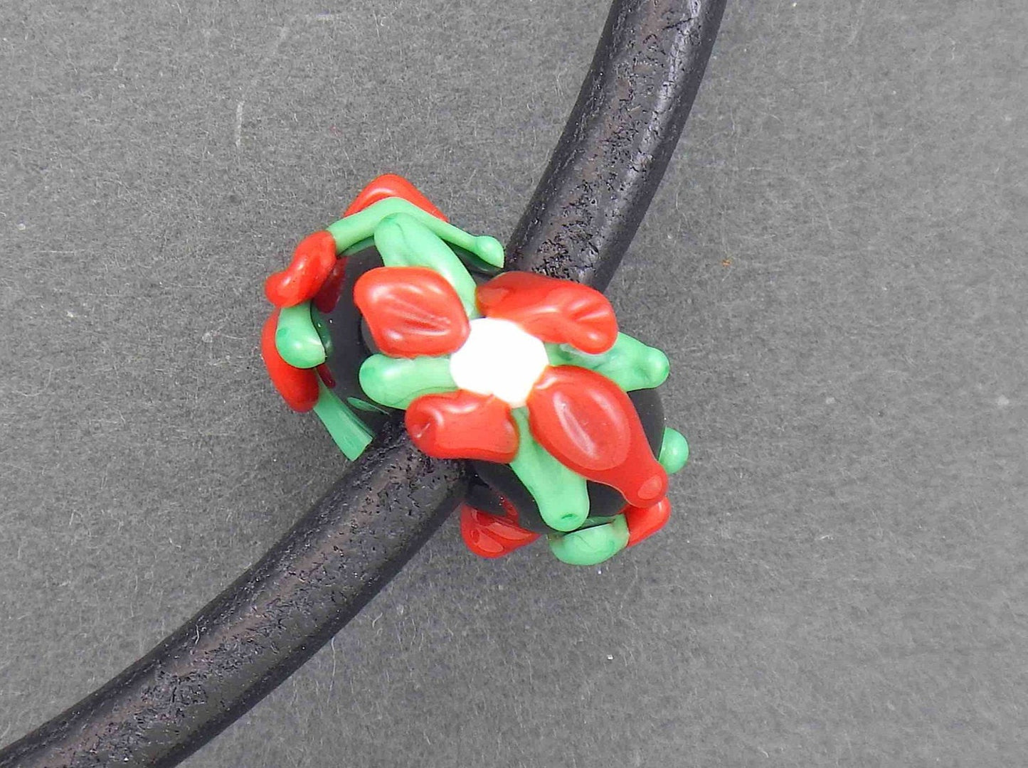 Choker necklace with black glass bead (Murano-style glass handmade in Montreal), 3-dimensional flowers in red-green-white, black leather cord, stainless steel clasp