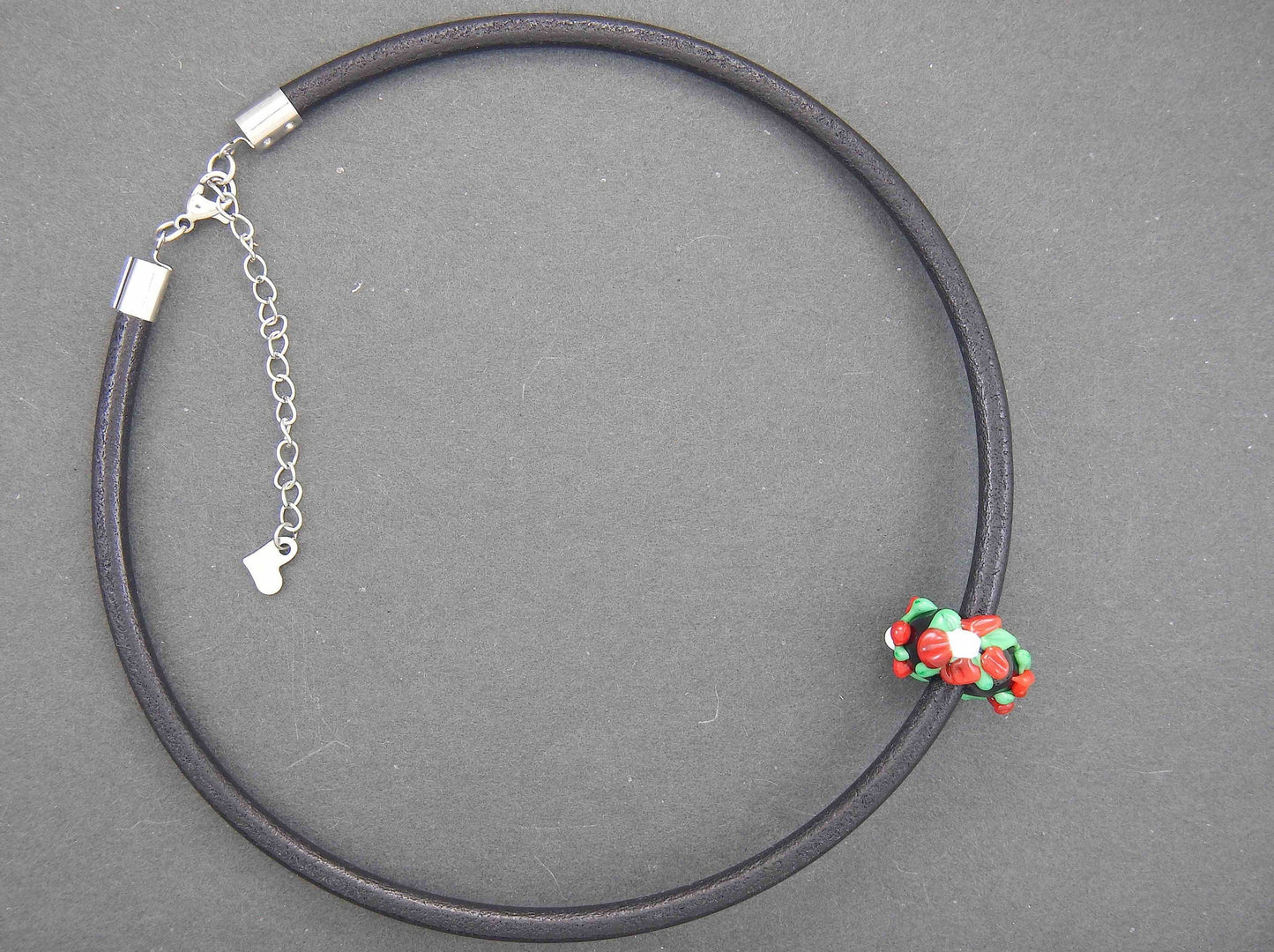 Choker necklace with black glass bead (Murano-style glass handmade in Montreal), 3-dimensional flowers in red-green-white, black leather cord, stainless steel clasp