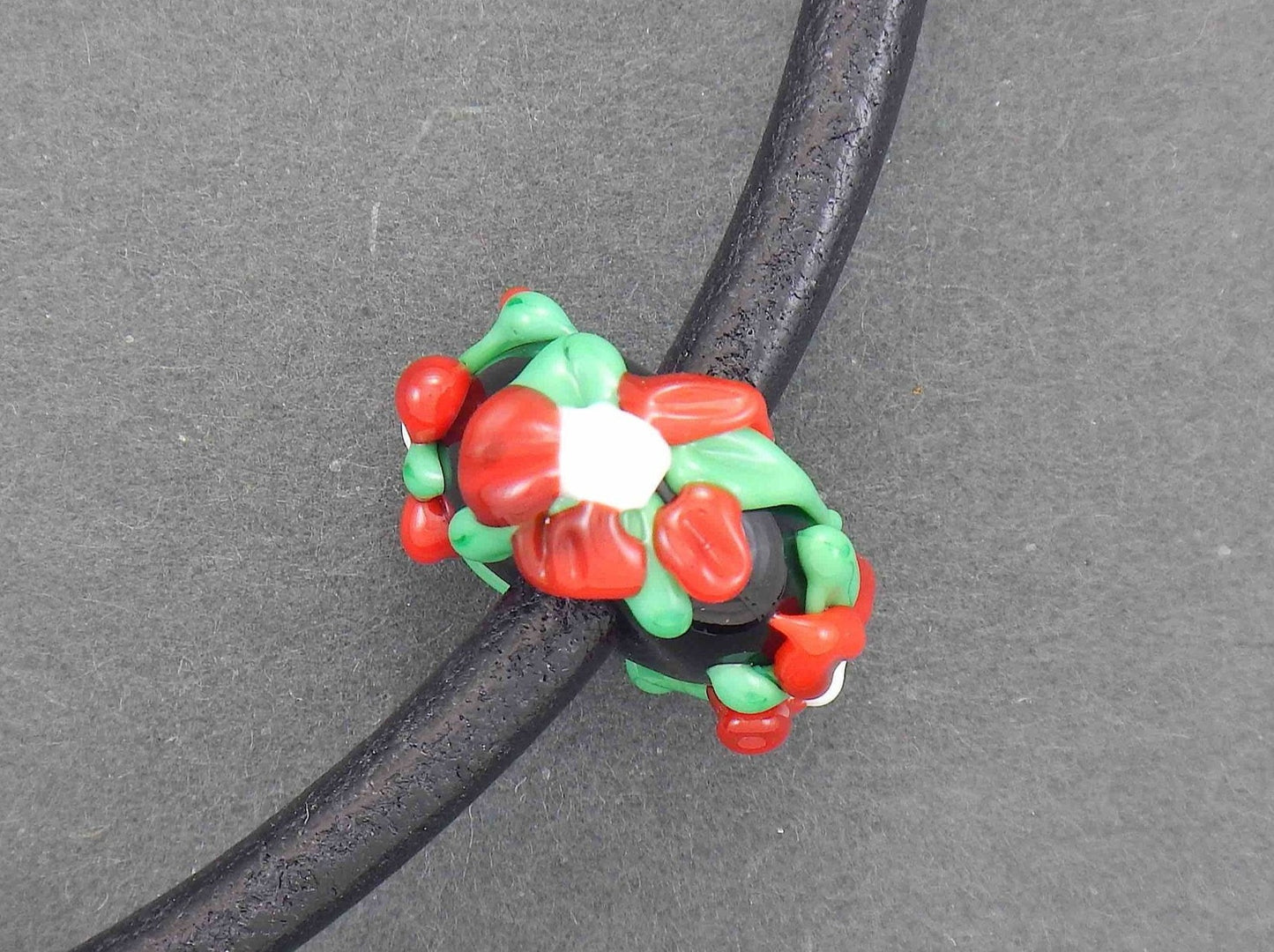 Choker necklace with black glass bead (Murano-style glass handmade in Montreal), 3-dimensional flowers in red-green-white, black leather cord, stainless steel clasp