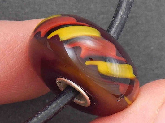 Choker necklace with burgundy red glass bead (Murano-style glass handmade in Montreal), red and yellow cane pattern, black leather cord, stainless steel clasp