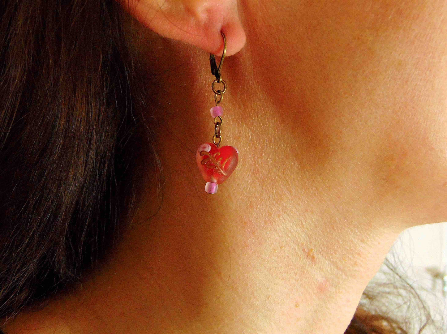 Long earrings with small frosted red glass hearts, rose details, brass hooks
