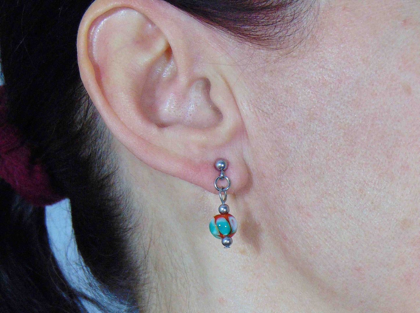 Short earrings with burnt orange glass balls, white and green dots (Murano-style glass handmade in Montreal), stainless steel posts
