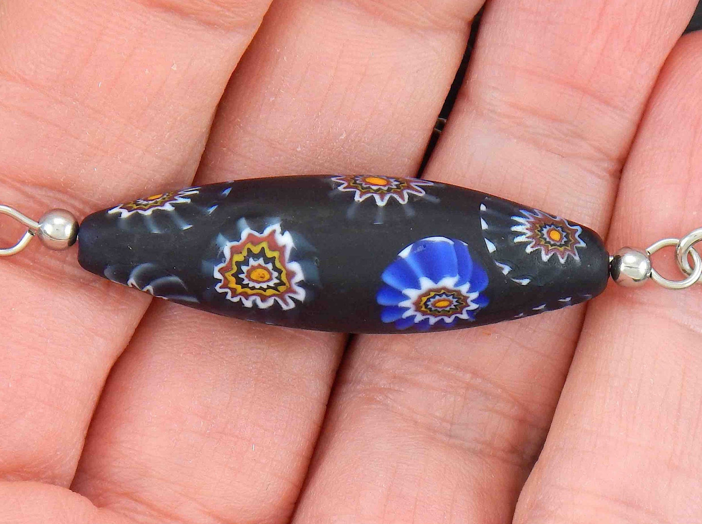 14-inch necklace with matte black Murano glass pointed cylinder, blue and brown murines patterns, stainless steel chain