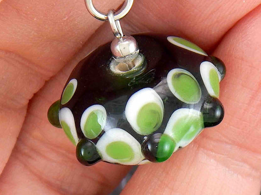 14-inch necklace with black saucer-shaped Murano glass bead, 3-dimensional green and white dots, stainless steel chain