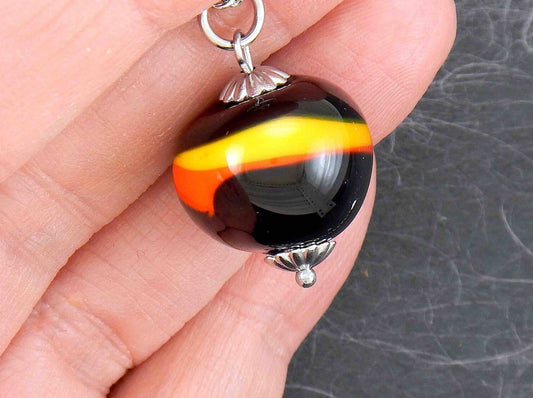 14-inch necklace with funky black ball marbled in red and yellow (Murano-style glass handmade in Montreal), stainless steel chain