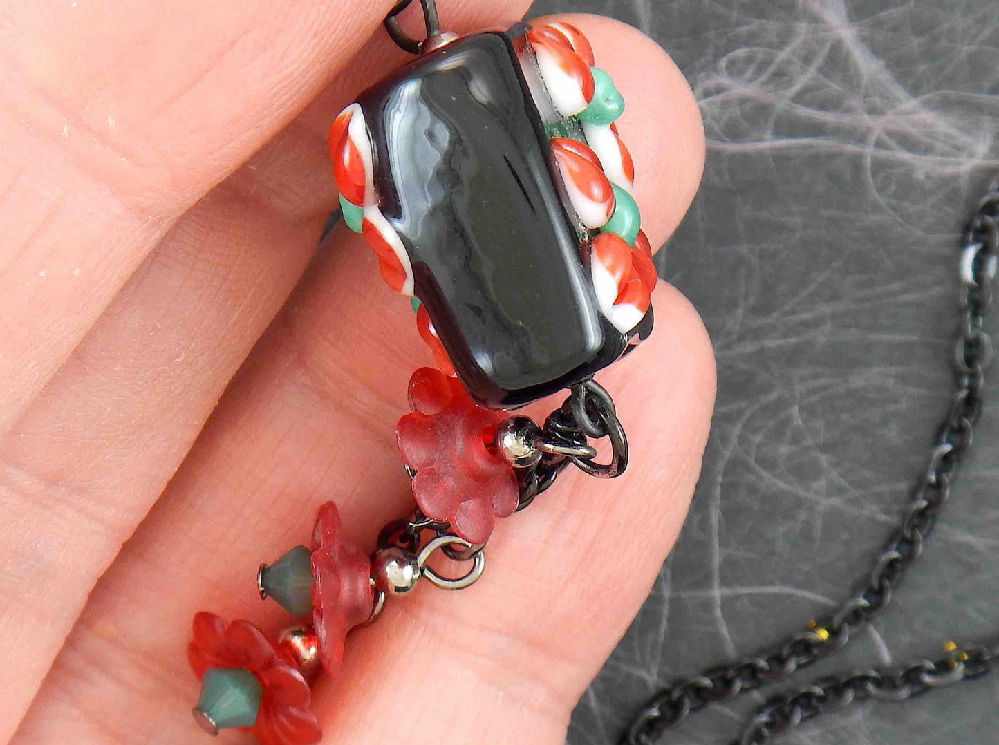 24-inch necklace with black Murano glass square, red-green 3D flowers, pendants with vintage lucite flowers and green Swarovski crystals, black stainless steel chain
