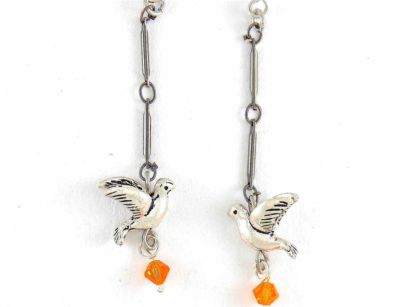 Long earrings with small pewter flying birds and orange Swarovski crystals, metal hooks