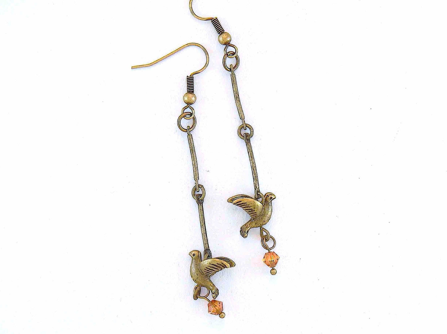 Long earrings with small brass flying birds and burnt orange Swarovski crystals, brass hooks