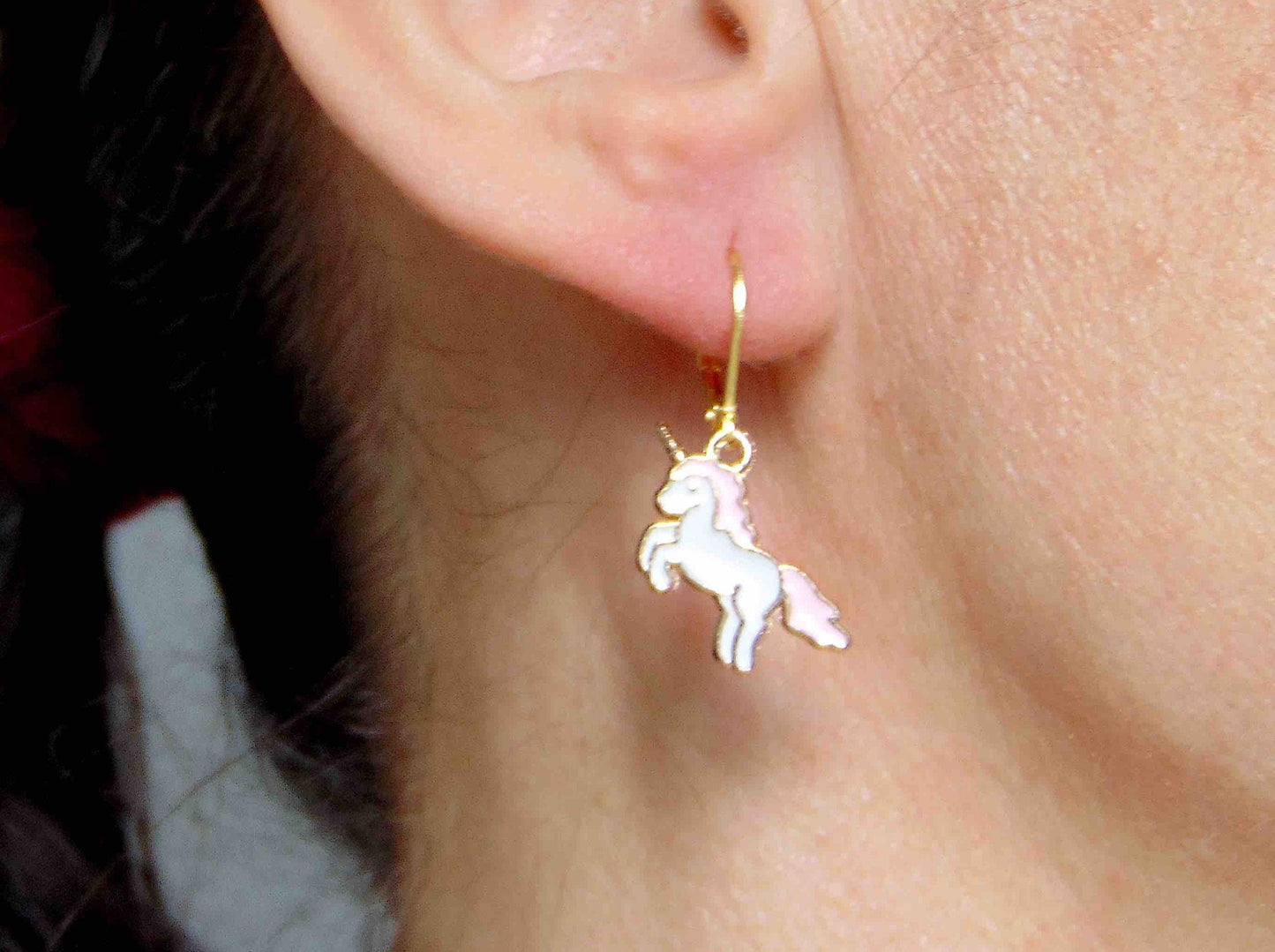 Short earrings with white and pink enamelled jumping unicorns, gold-toned stainless steel lever back hooks