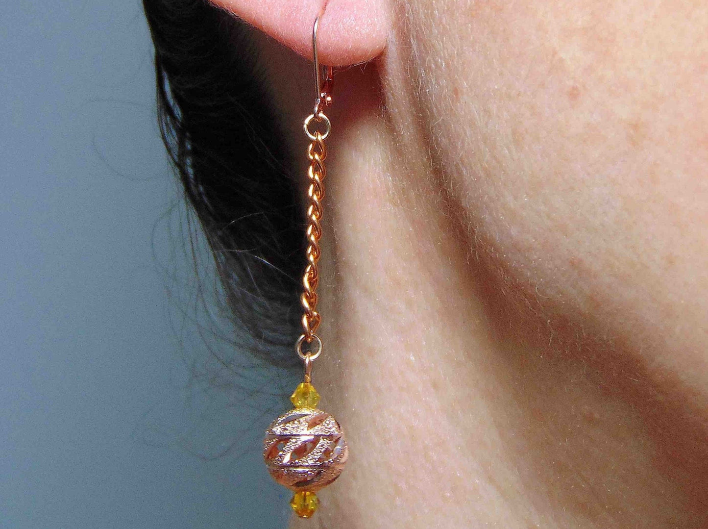 Long earrings with rose gold filigree balls and Swarovski crystals, rose-gold plated metal lever back hooks