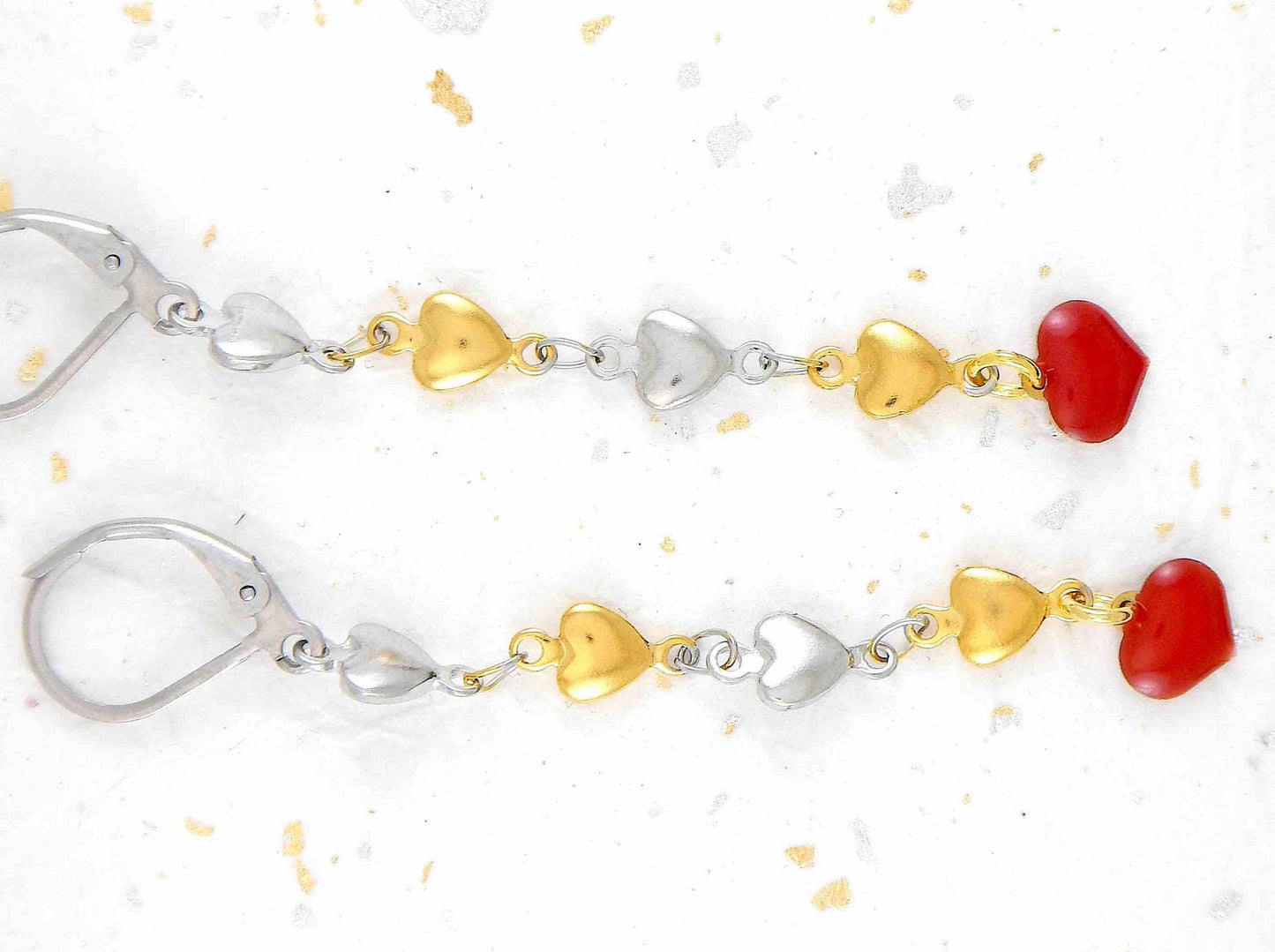 Long earrings with delicate alternating silver and gold heart chain, red enamelled heart, stainless steel lever back hooks
