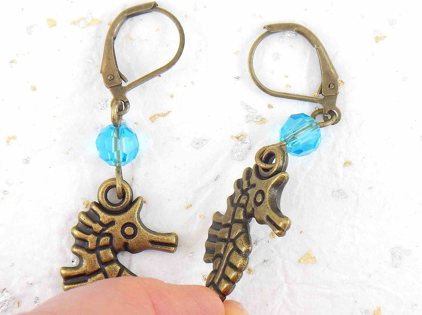 Long earrings with brass seahorses and turquoise Swarovski crystals, brass lever back hooks