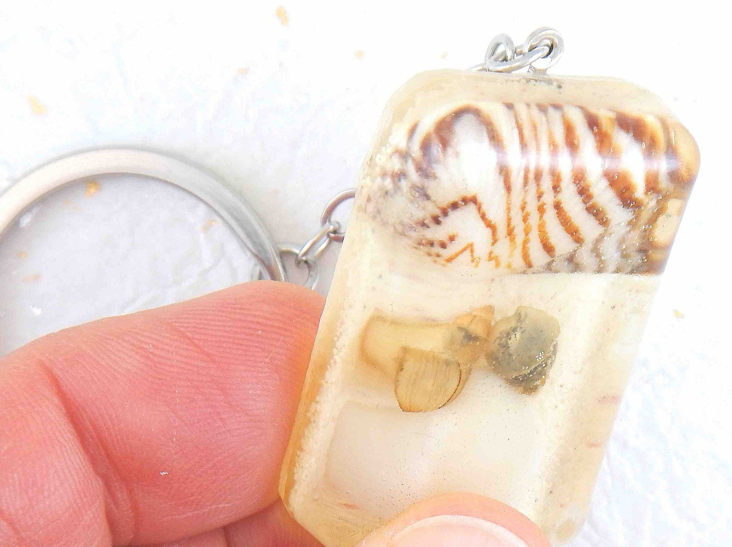Keychain with handmade resin rectangle, white beach sand, brown and white striped shells, stainless steel chain