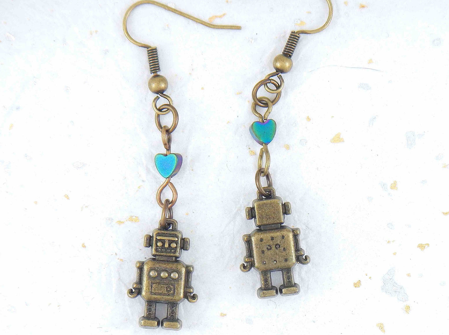 Long earrings with small brass robots and iridescent hematite hearts, brass hooks
