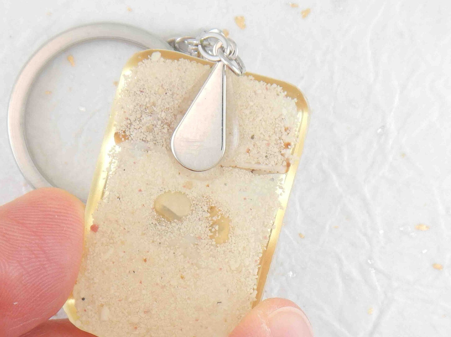 Keychain with handmade resin rectangle, white beach sand, brown and white striped shells, stainless steel chain