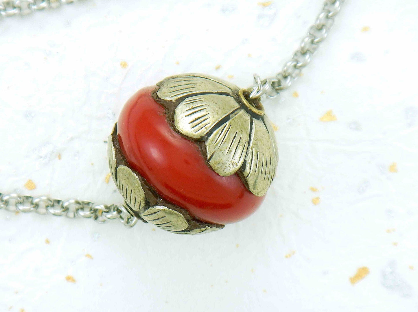 14-inch necklace with pewter and red resin Tibetan ball, stylized flower caps, stainless steel chain