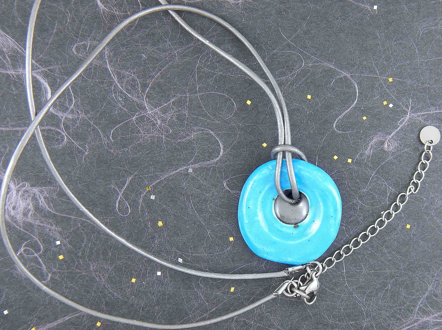 19-inch necklace with round turquoise and dark silver ceramic pendant handmade in Montreal, dark silver gray leather cord, stainless steel clasp