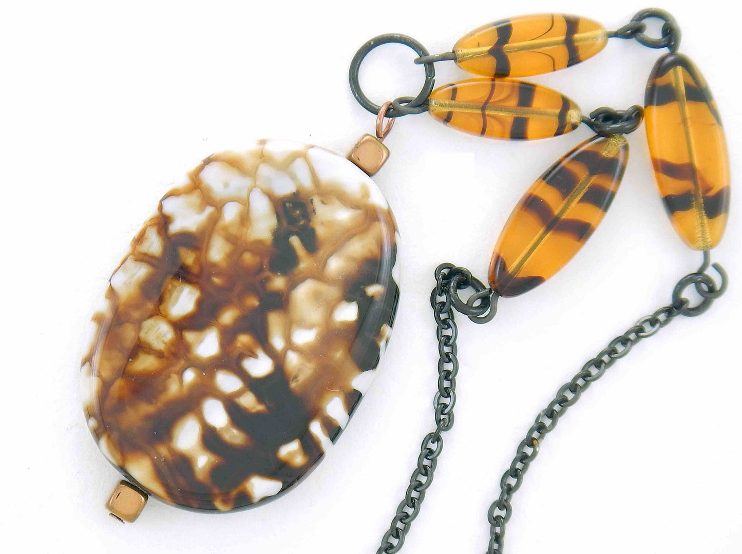 26-inch necklace with speckled black-brown-white jasper stone pendant, striped amber glass beads, black stainless steel chain