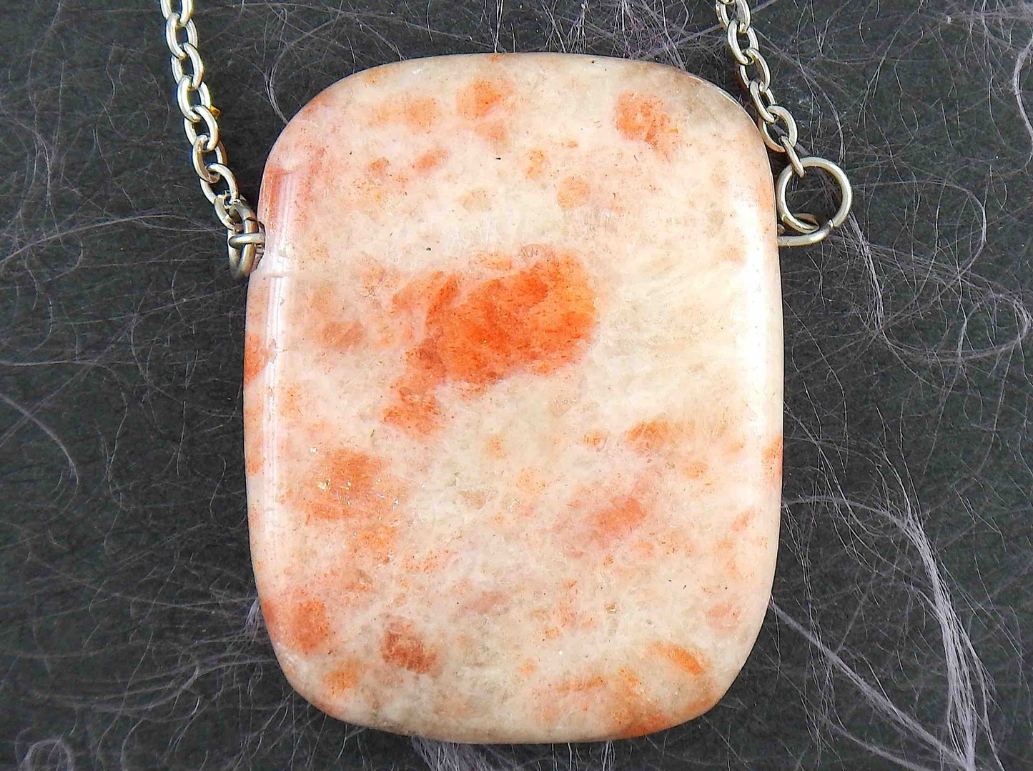 33-inch necklace with smooth rectangular white and rose gold sunstone pendant, stainless steel chain