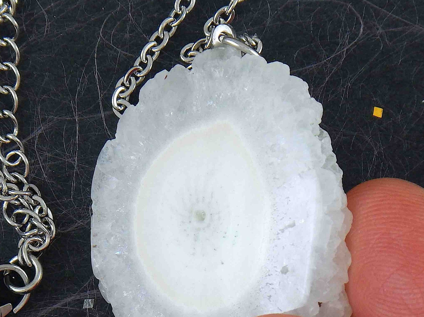 16-inch necklace with large white solar quartz stone circular pendant, drop-shaped center, stainless steel chain
