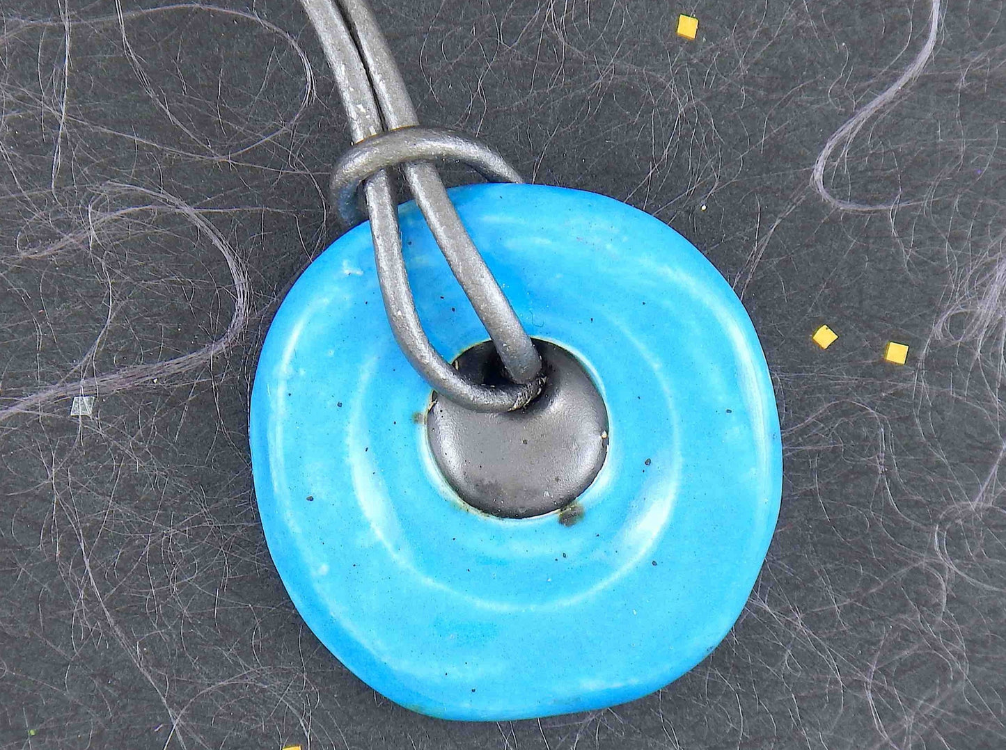 19-inch necklace with round turquoise and dark silver ceramic pendant handmade in Montreal, dark silver gray leather cord, stainless steel clasp