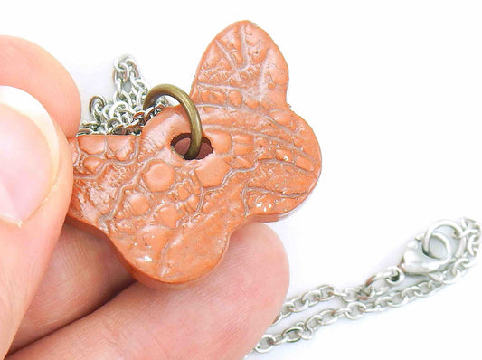 16-inch necklace with terra cotta butterfly ceramic pendant handmade in Montreal, lace pattern, stainless steel chain