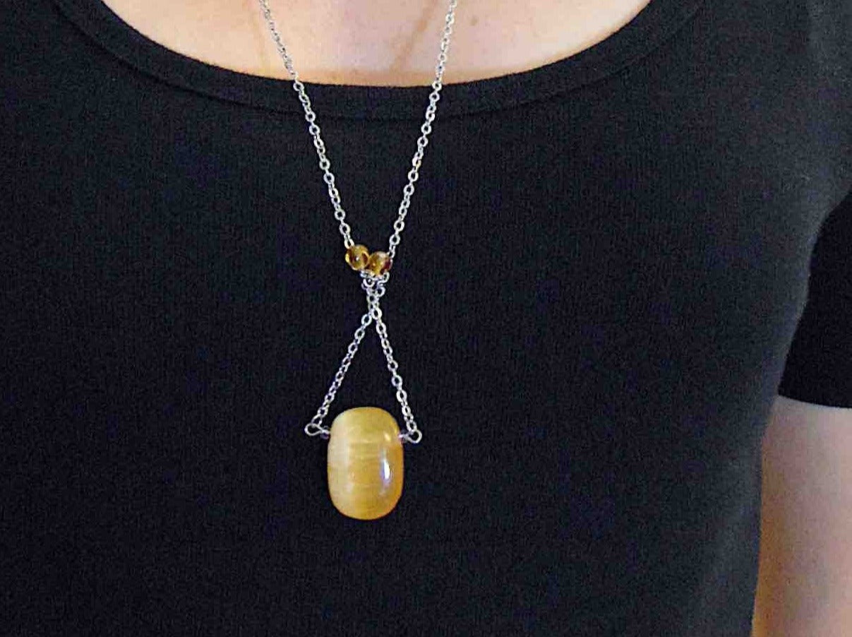 30-inch necklace with large rectangular honey yellow calcite stone pendant, triangular layout, matching glass beads, stainless steel chain