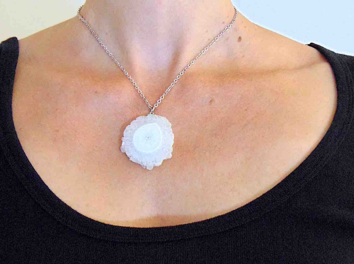 16-inch necklace with large white solar quartz stone circular pendant, drop-shaped center, stainless steel chain
