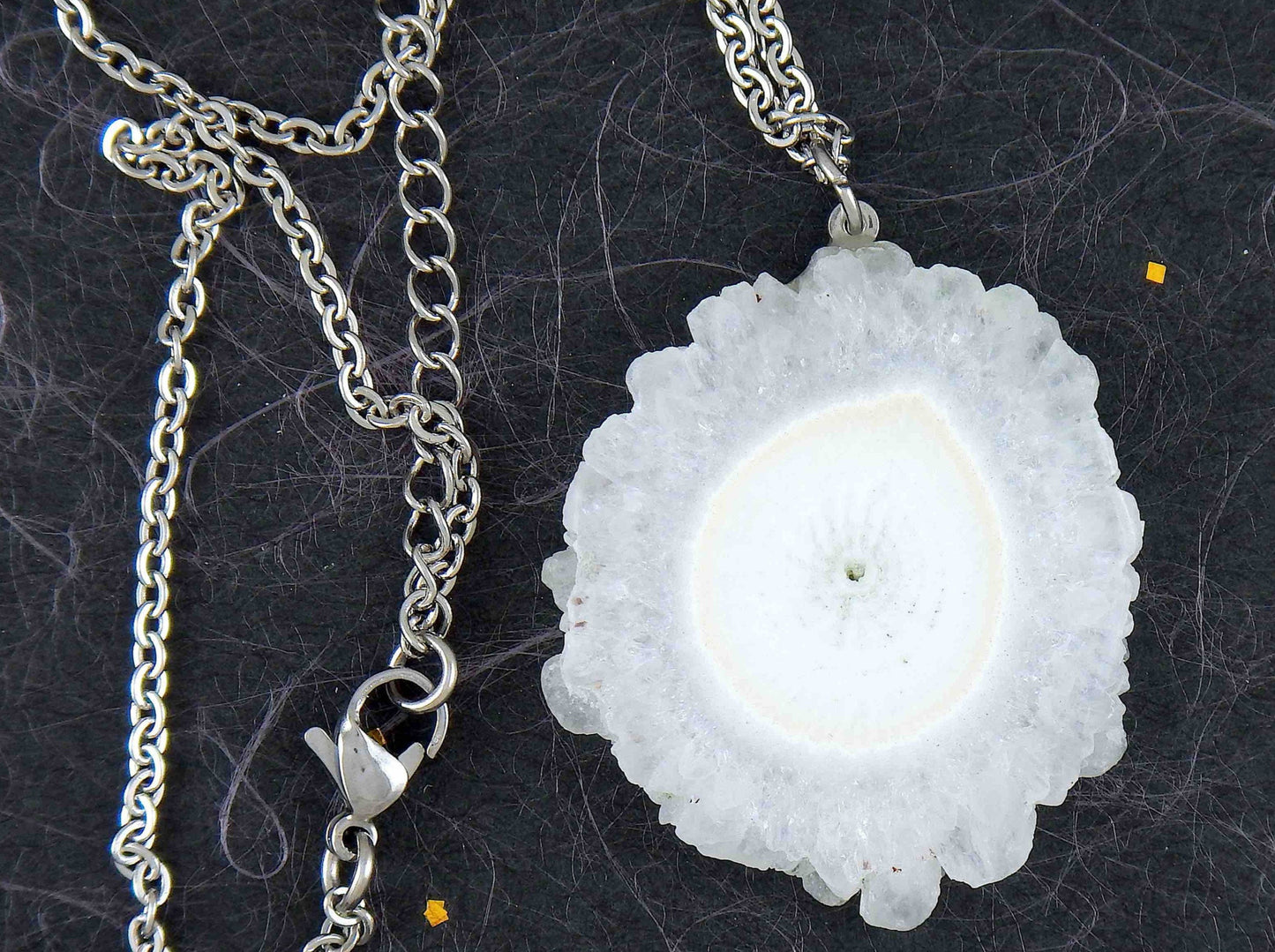 16-inch necklace with large white solar quartz stone circular pendant, drop-shaped center, stainless steel chain