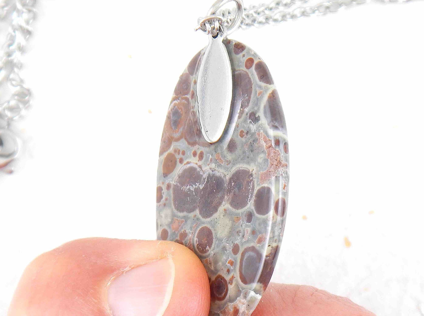 16-inch necklace with oval leopard jasper stone pendant, burgundy and chocolate brown dots on blue-grey background, stainless steel chain