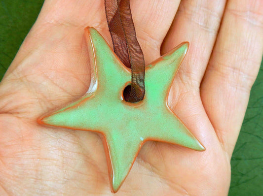Ornament with mint green and terracotta ceramics star handmade in Montreal, chocolate brown organza ribbon