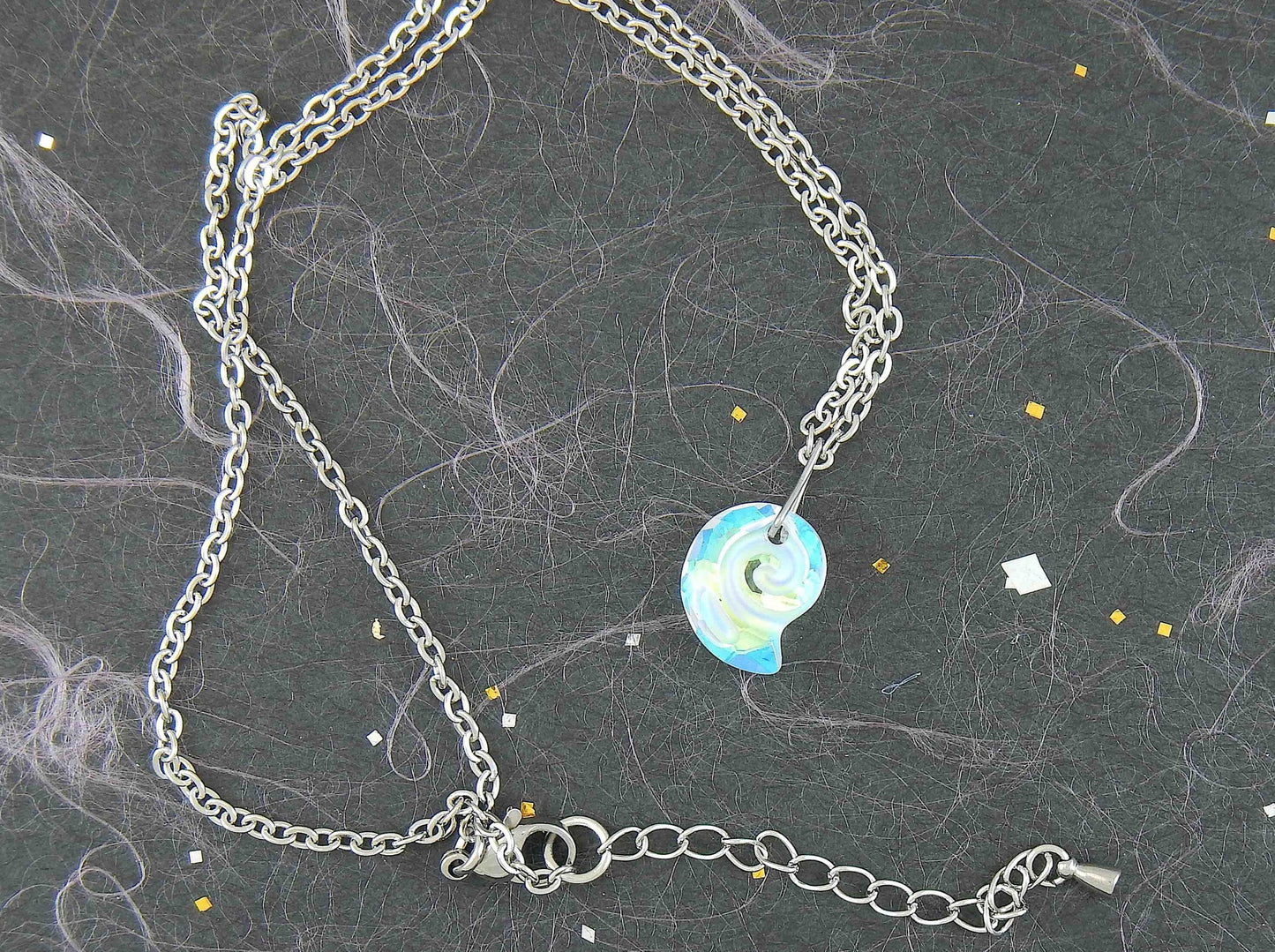 15-inch necklace with 15mm iridescent clear swirl shell Swarovski crystal pendant, stainless steel chain