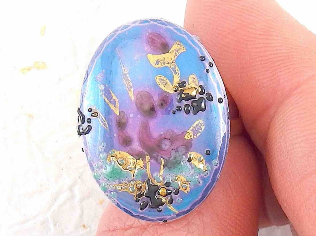 Finger ring with hand-painted blue-pink-gold-black oval vintage glass cabochon, abstract flower pattern, gold-toned stainless steel adjustable base