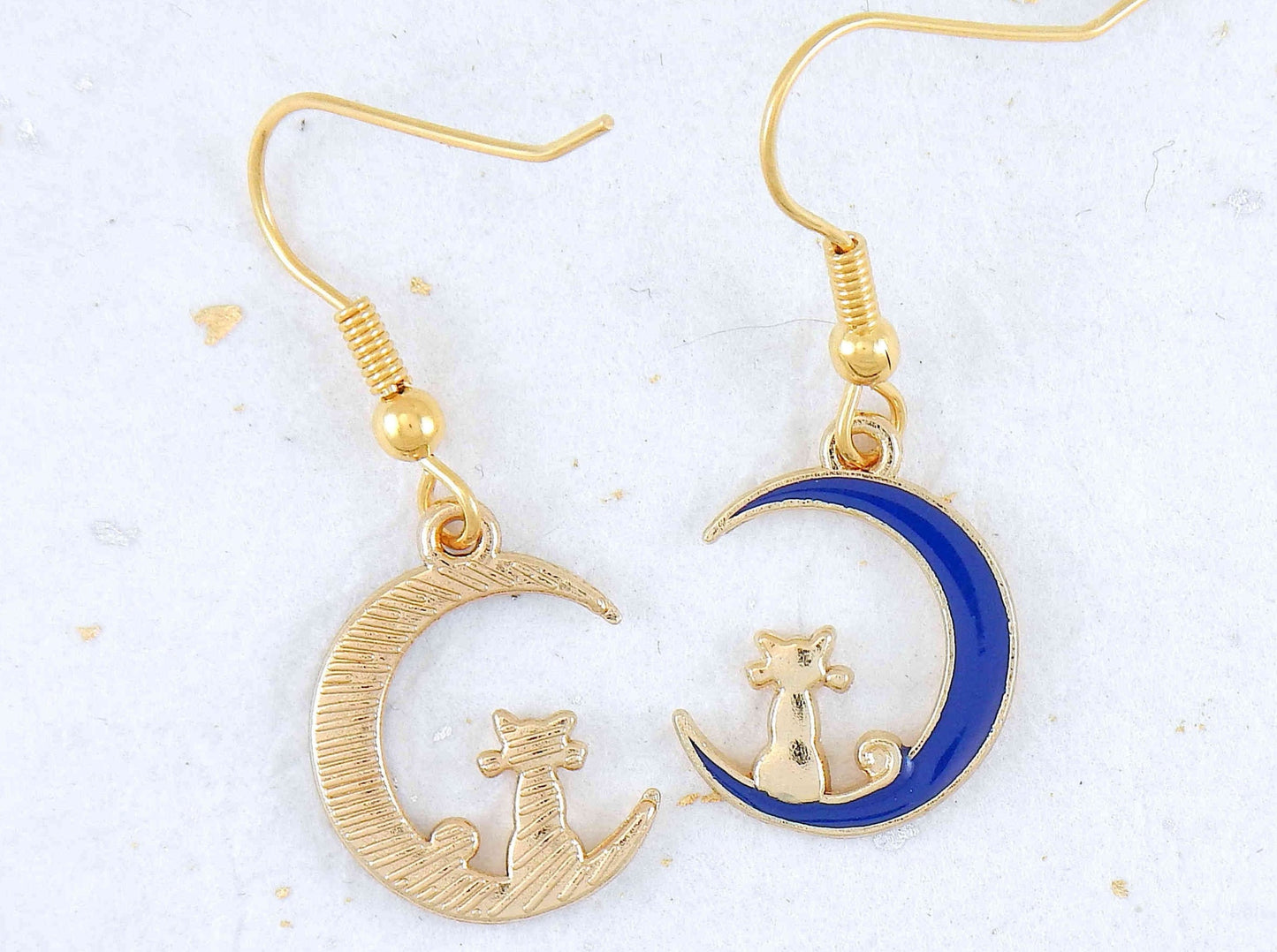 Short earrings with tiny gold cats sitting on blue enamelled moon crescents, gold-toned stainless steel hooks