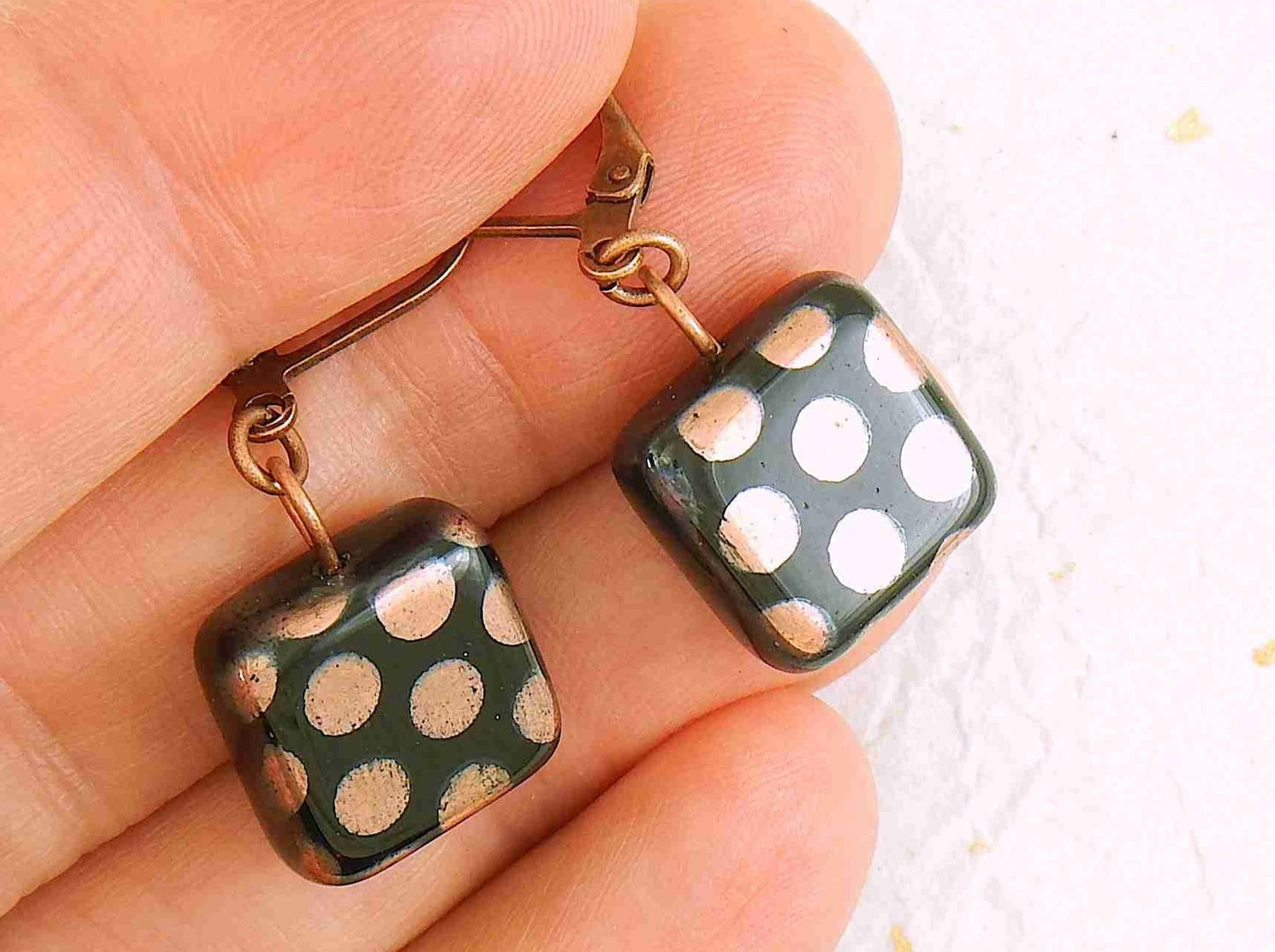 Short earrings with small shiny black Czech glass squares, small multicolored or copper dots, silver or rose gold-toned stainless steel lever back hooks
