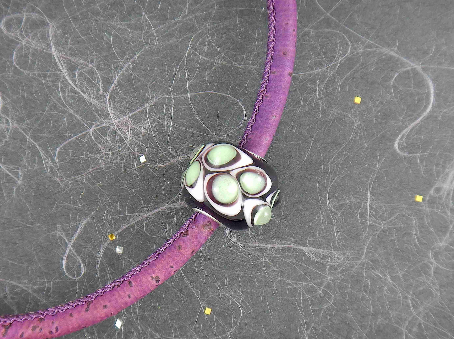 Choker necklace with deep purple cylinder glass bead (Murano-style glass handmade in Montreal), 3-dimensional white-translucent green dots, purple cork cord, stainless steel clasp