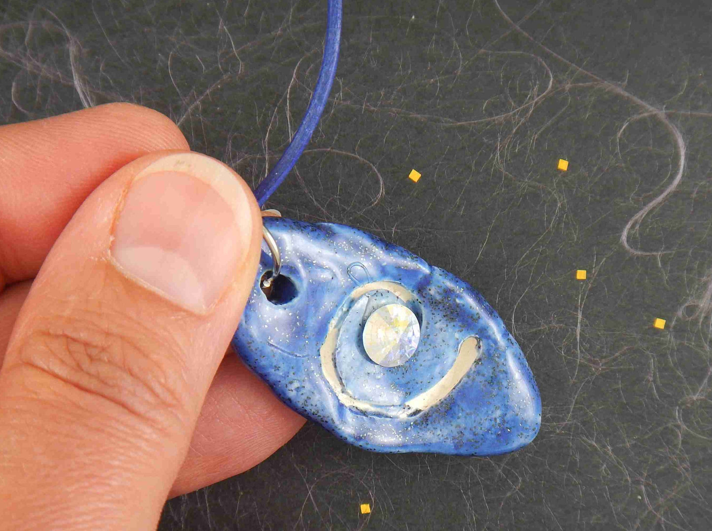 18-inch necklace with jean blue spiralled shell-like pendant handmade in Montreal, 6mm Crystal AB Swarovski Rivoli chaton, jean blue leather cord, stainless steel clasp