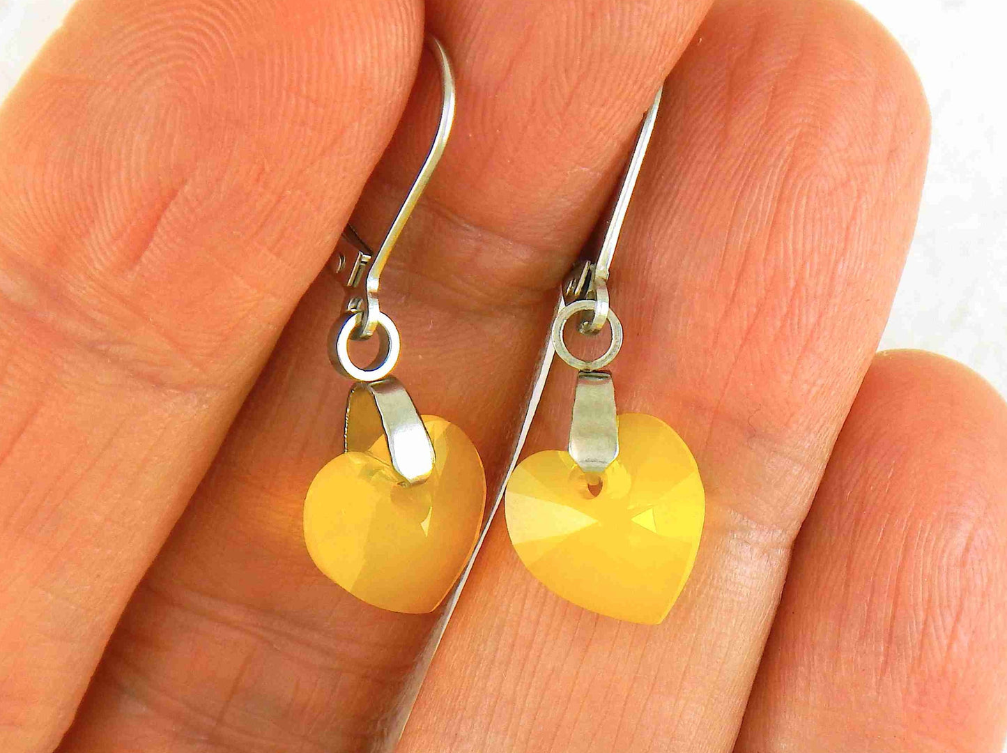 Short earrings with 10mm faceted Yellow Opal Swarovski crystal hearts, stainless steel lever back hooks