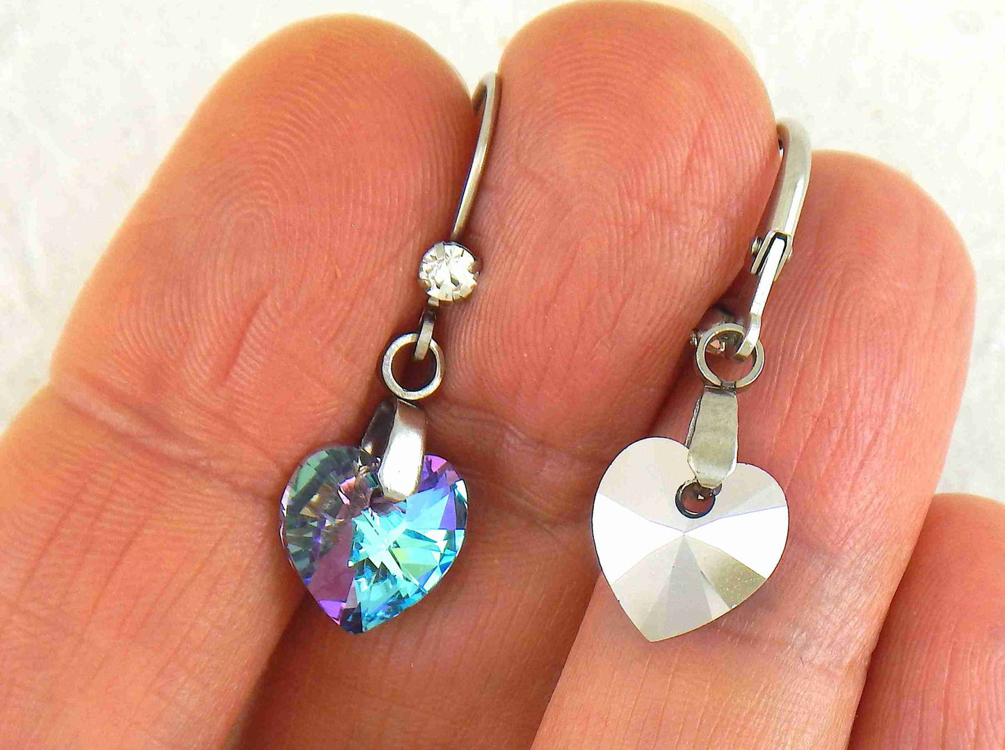 Short earrings with 10mm faceted Vitrail Light (sky blue and lilac) Swarovski crystal hearts, stainless steel lever back hooks with tiny clear crystals