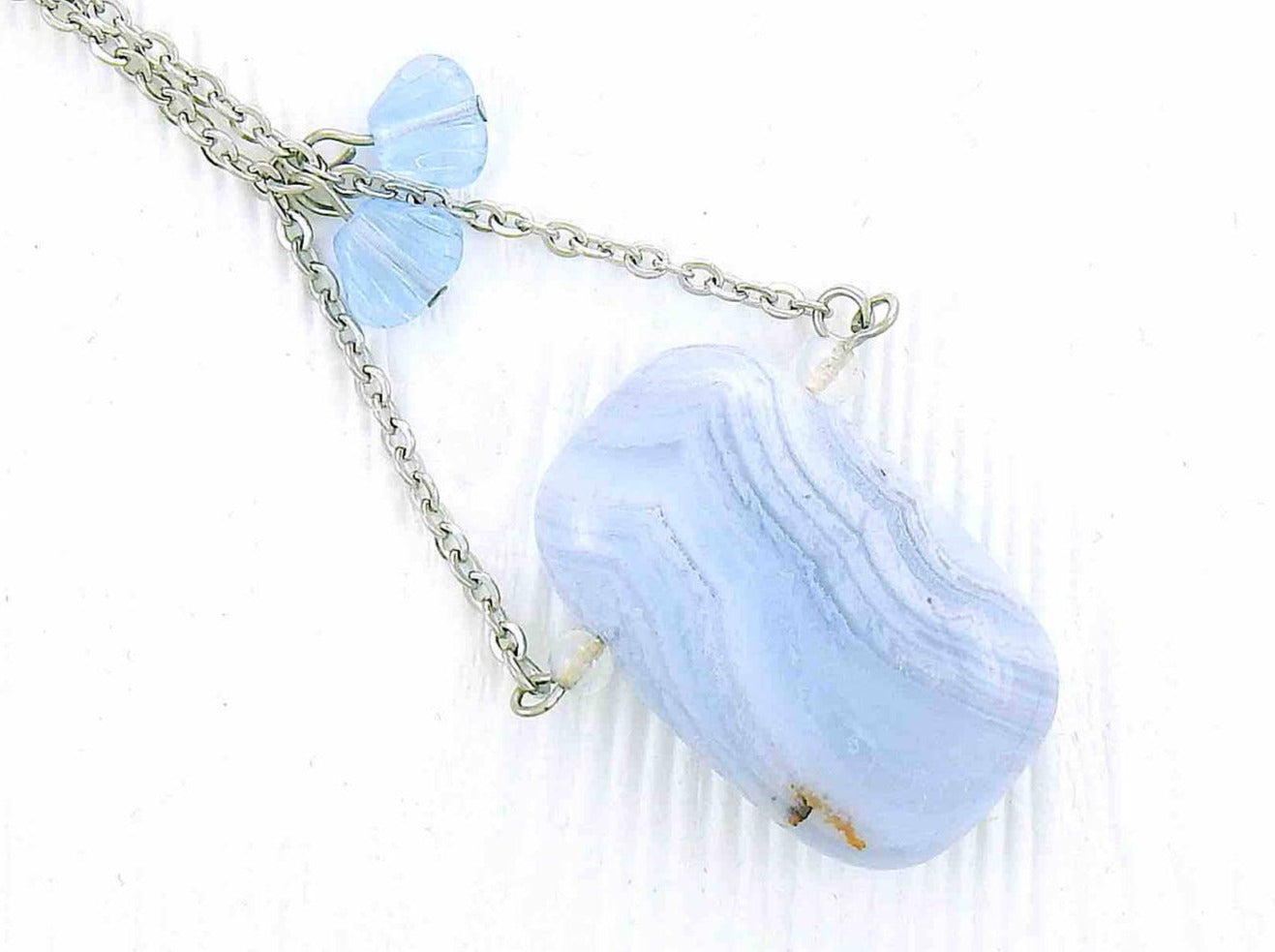 31-inch necklace with large rectangular blue lace agate stone pendant in triangular layout, matching glass beads, stainless steel chain