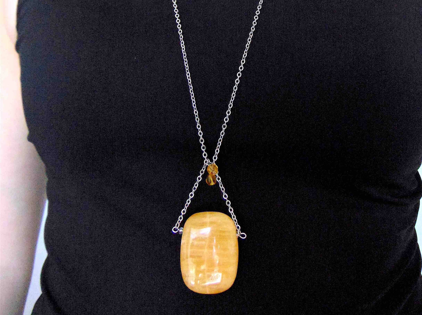 30-inch necklace with large rectangular honey yellow calcite stone pendant, triangular layout, matching glass beads, stainless steel chain