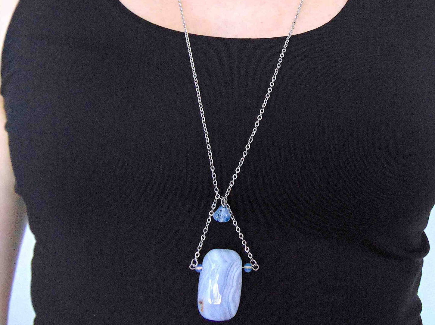 31-inch necklace with large rectangular blue lace agate stone pendant in triangular layout, matching glass beads, stainless steel chain