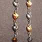 Long earrings with delicate alternating silver and gold heart chain, stainless steel lever back hooks