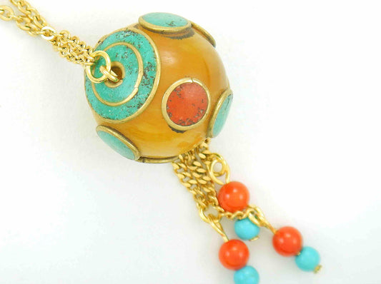 28-inch necklace with round honey yellow Tibetan bead, coral and turquoise inserts, assorted pendants, gold-toned stainless steel chain