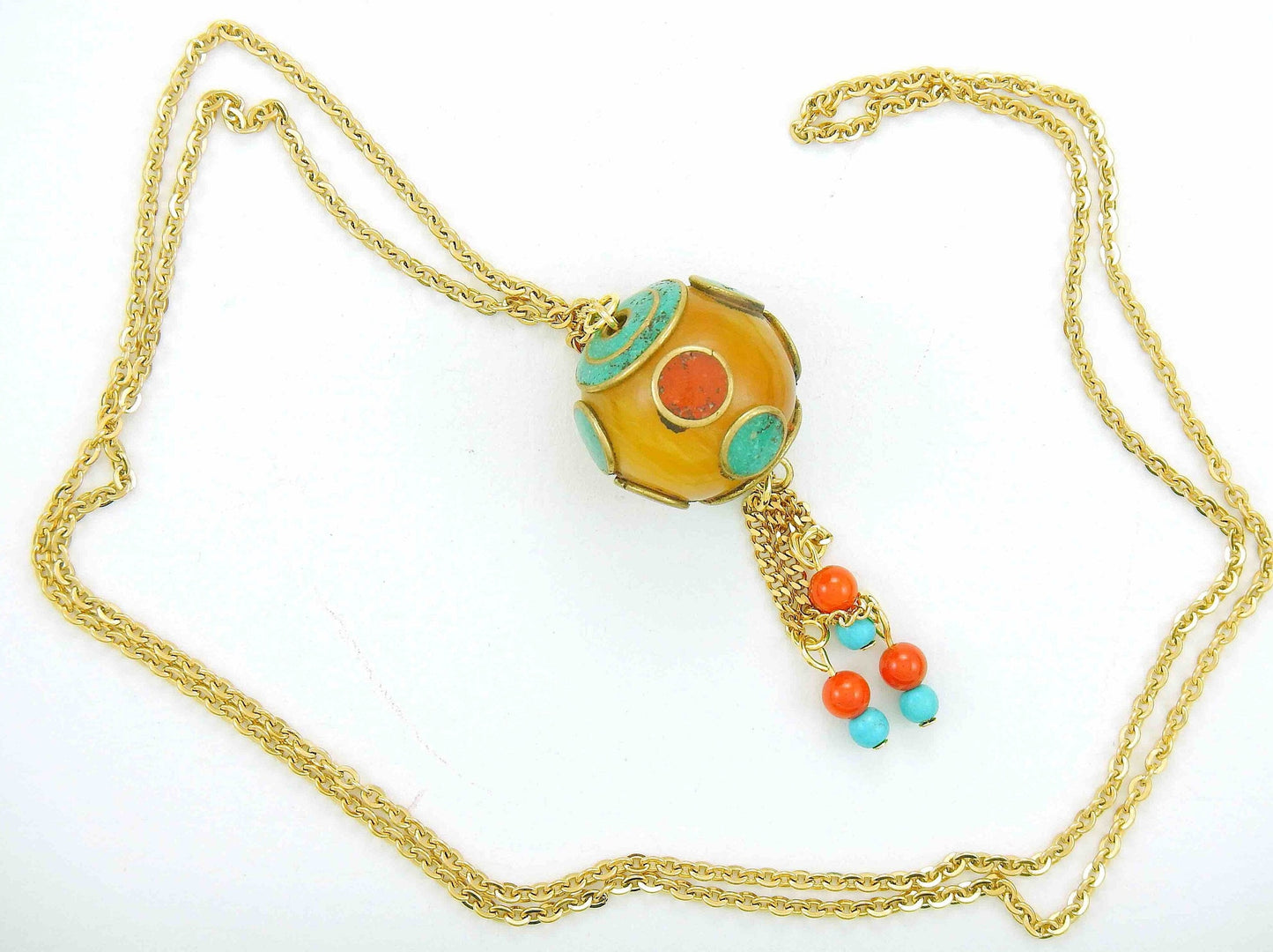 28-inch necklace with round honey yellow Tibetan bead, coral and turquoise inserts, assorted pendants, gold-toned stainless steel chain