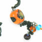 27-inch necklace with elongated glass ball and matching pendants in bright orange-black-blue (Murano-style glass handmade in Montreal), black stainless steel chain